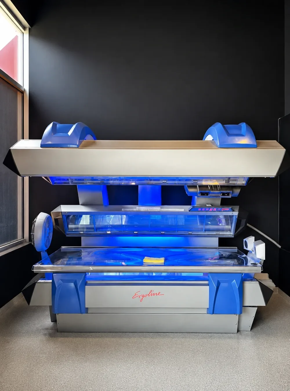 Blue-lit UV tanning bed at Sunsational Tan